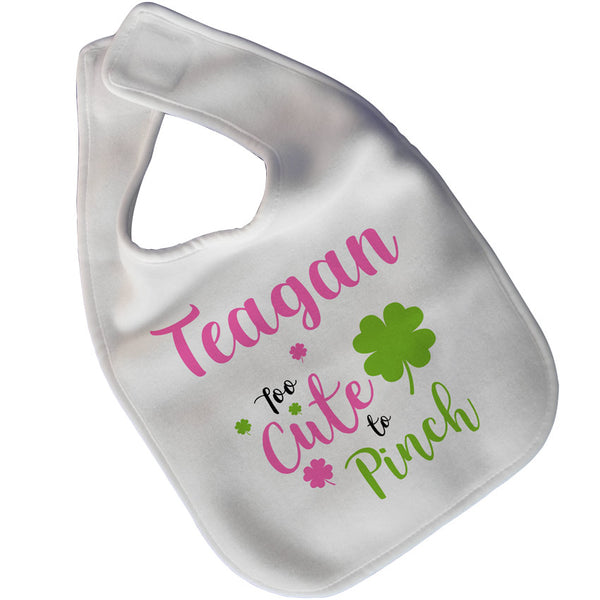 White velcro closure baby big with shamrocks in pink and green  along with any name and quote saying too cute to pinch