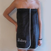woman wearing black velour cotton towel wrap with embroidered name and piping