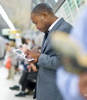 Commuter studying on an iPad in US, UK or Canada