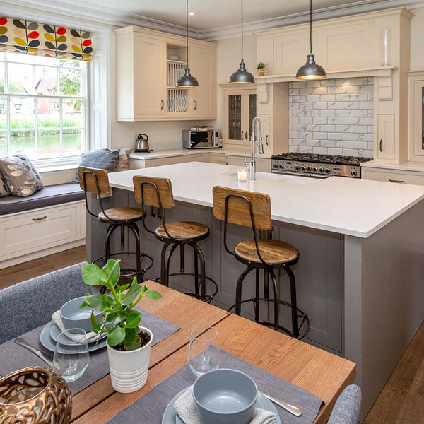 natually lighted residential designed kitchen with hanging light fixtures