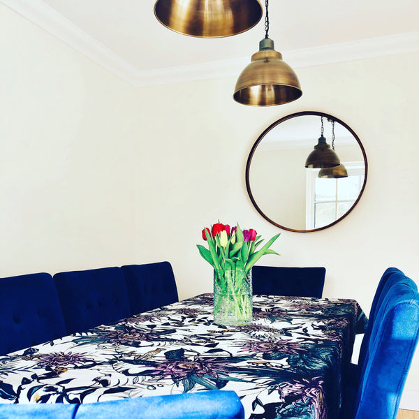 Blue velvet chairs and vintage pendant lights in a dining room