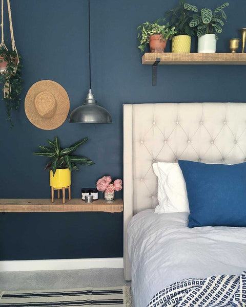 Navy walls paired with pewter retro lighting
