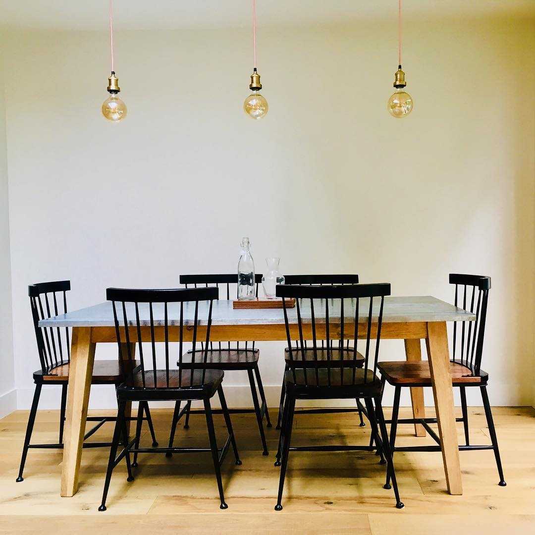 Bare lights hanging over a dining table