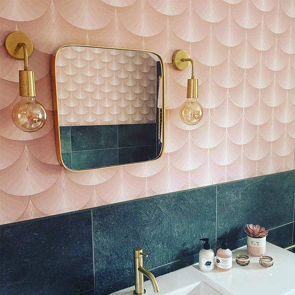 Pink and blue bathroom interior with brass lights