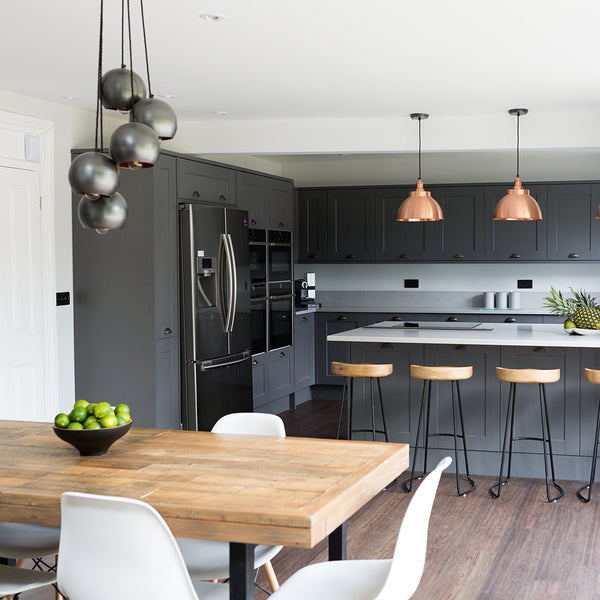 Grey kitchen interior with industrial pendant lights