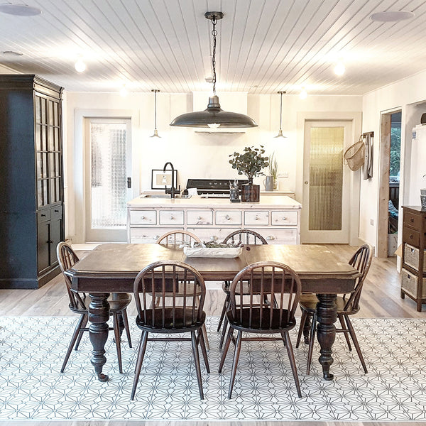 Industrial oversized pendant light above a dining room table