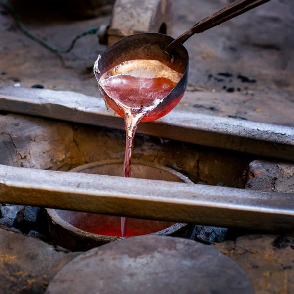 Pure copper being poured to create handcrafted lighting