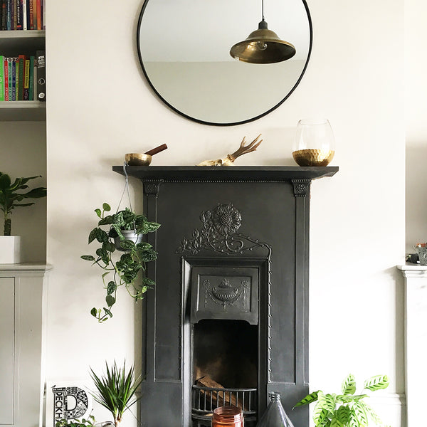 Cosy living room interior with a black fireplace and industrial pendant light