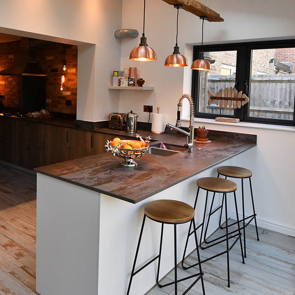 Kitchen interior with kitchen island and trio of copper lights