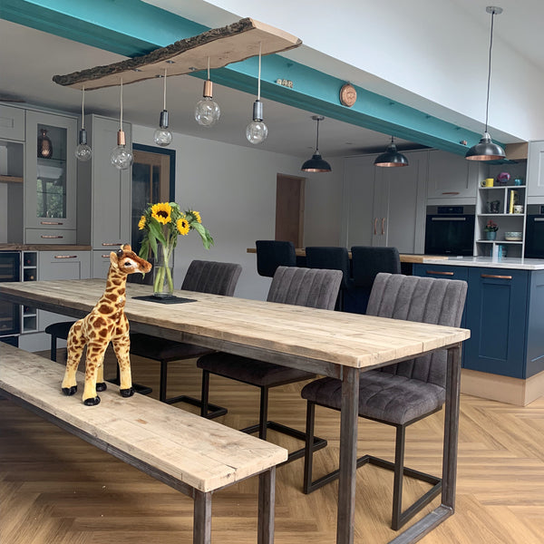 Open plan kitchen interior with industrial lights in a wooden beam