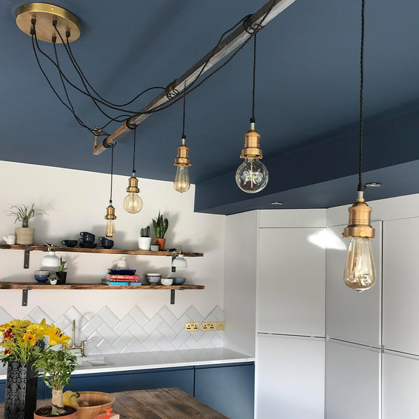 Blue kitchen interior with brass industrial lights