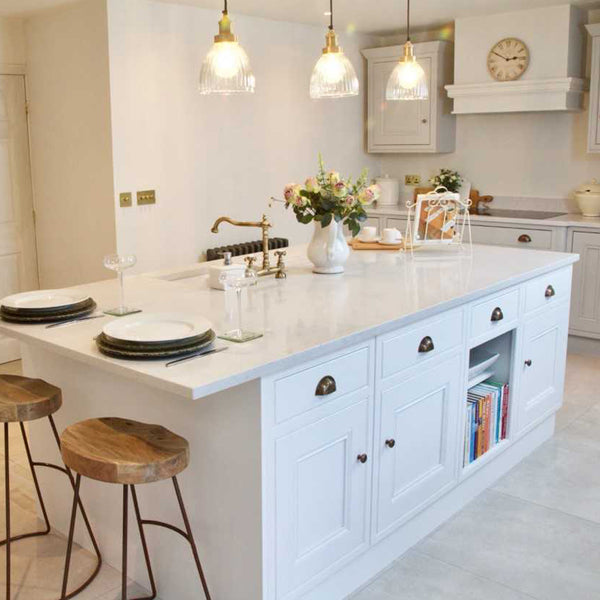 Country-style white kitchen interior with trio of pendants