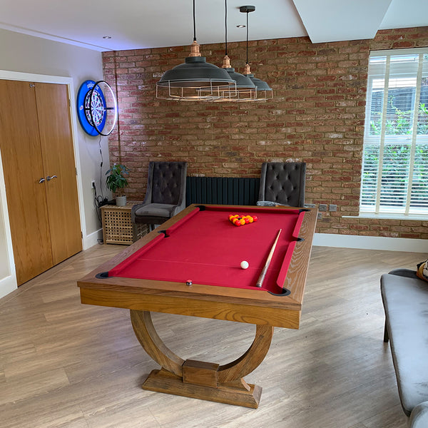 Games room in a home interior with industrial lighting placed above a pool table