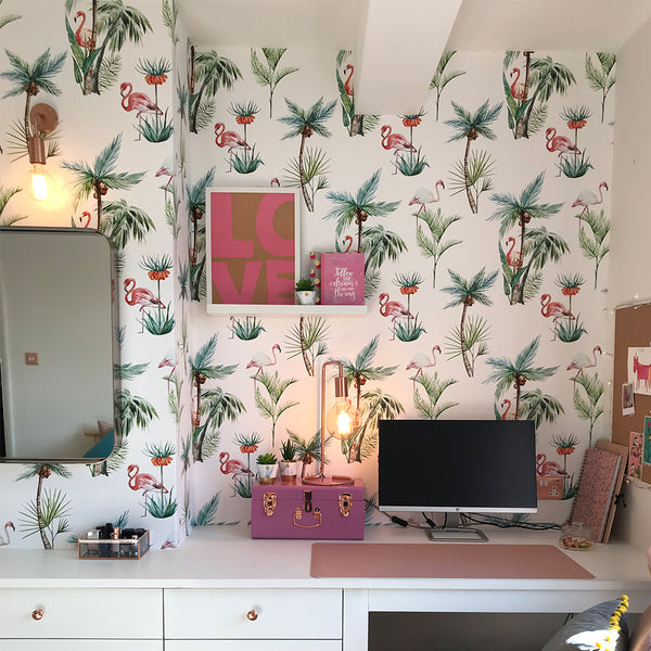 Office space in a bedroom interior with tropical wallpaper and copper lights