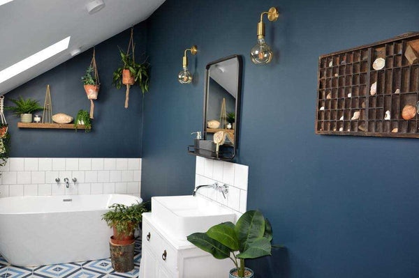 Blue bathroom interior with brass wall lights