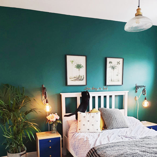 Green bedroom interior with glass pendant