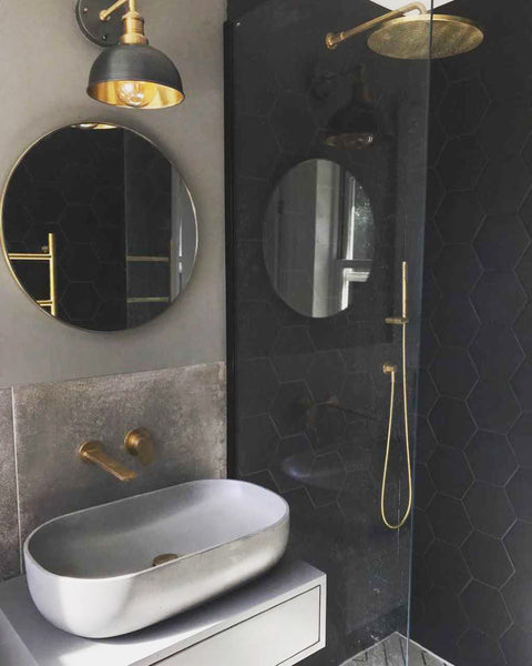 Brass accessories in a dark bathroom 