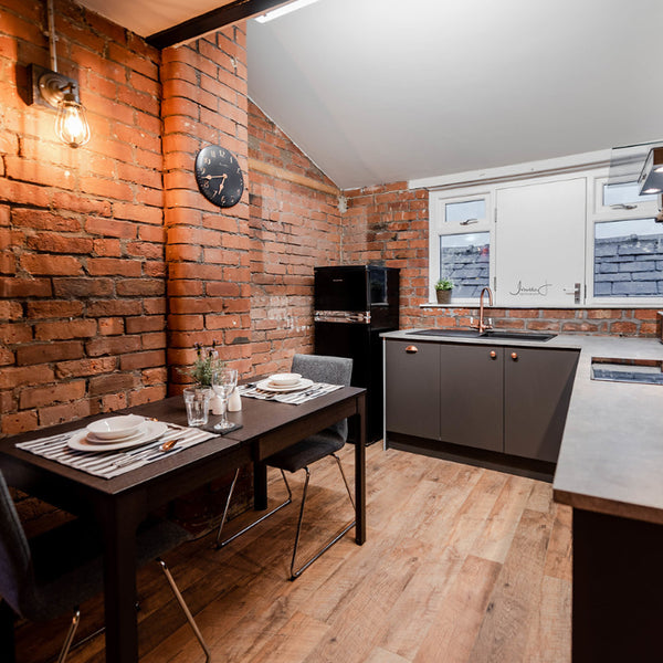 Kitchen interior with exposed brick walls and vintage wall light