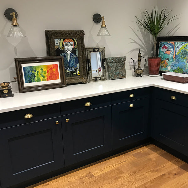 Kitchen interior with glass wall lights and artwork on cabinets
