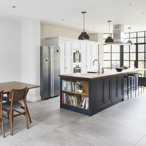 Kitchen interior with dark cabinets and pewter pendants