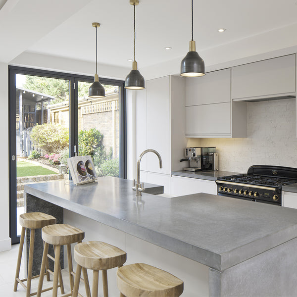 Trio of pewter pendants over a kitchen island