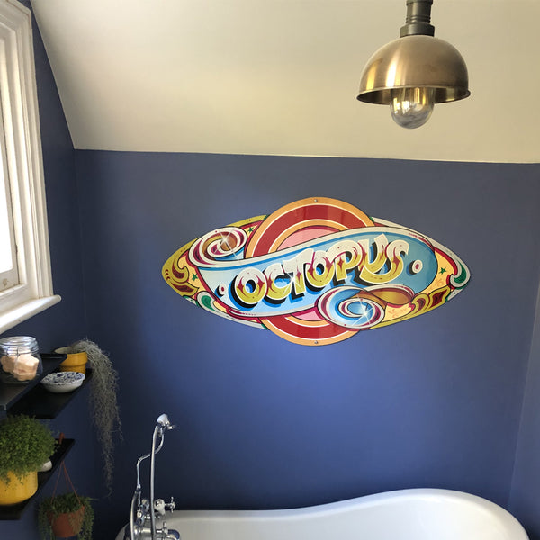 Navy bathroom decor with graffiti and brass pendant