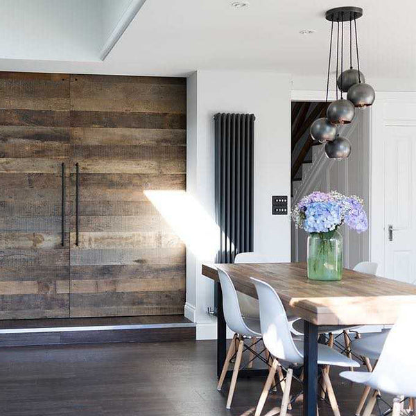 Dining room interior with wooden door and industrial globe pendant