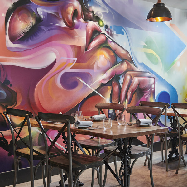 Graffiti wall and industrial ceiling lights in a restaurant 