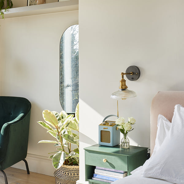 Cuban inspired bedroom interior with industrial wall light