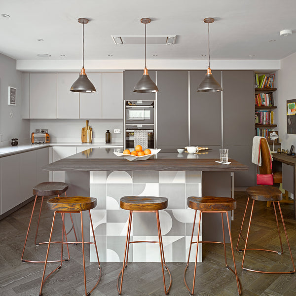 Kitchen island with three industrial style pendant lights above