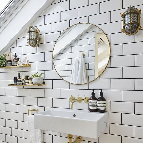 Bathroom interior with brass accessories and white tiles