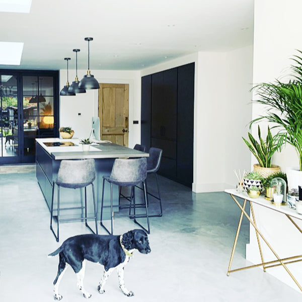 Kitchen interior with kitchen island and trio of pendants 