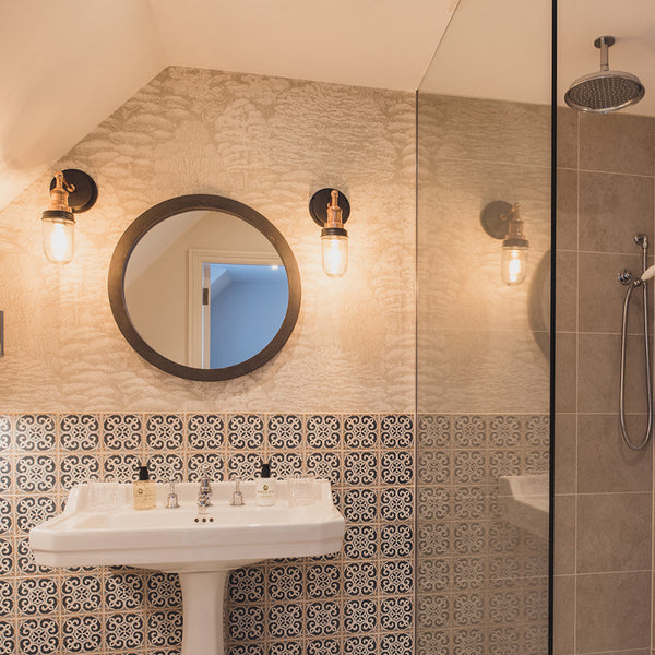 Bathroom with mirror and wall sconces