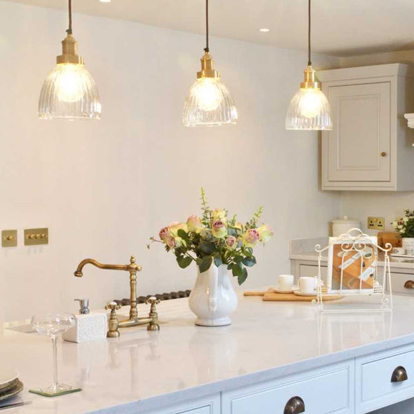 Trio of hanging glass pendants in a kitchen