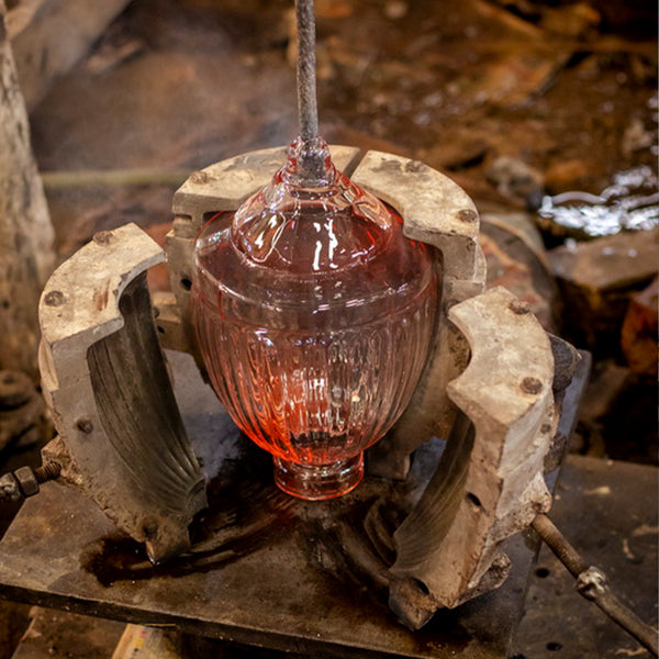 Glass light being formed in a mould