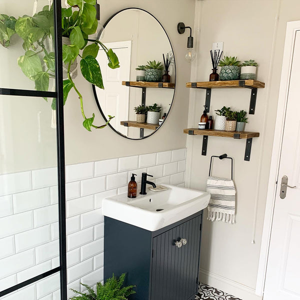 Bathroom with greenery and dark colour cabinet
