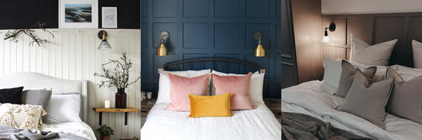 Dark bedroom with two golden wall lights