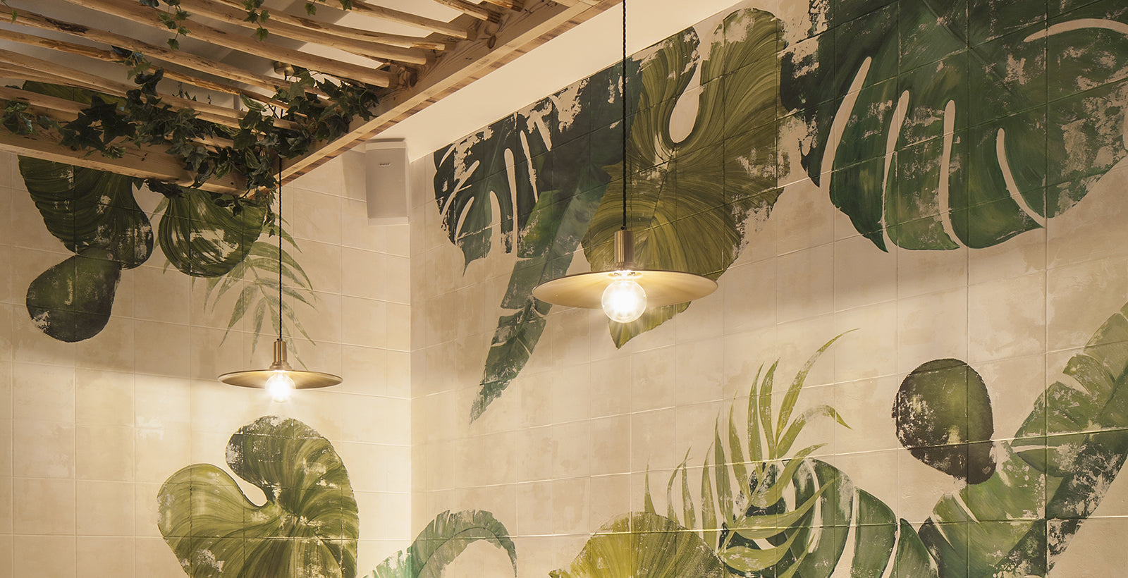hanging light against leaf wallpaper