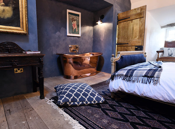 Blue bedroom interior with copper bath and waterproof lights