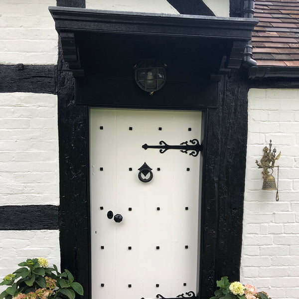 White Tudor door with black door frame 