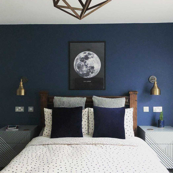 Bedroom with blue wall and industrial lights