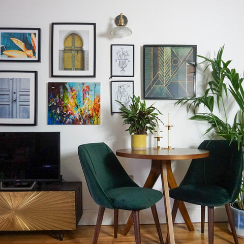 A colourful living room with wall art and wooden seating