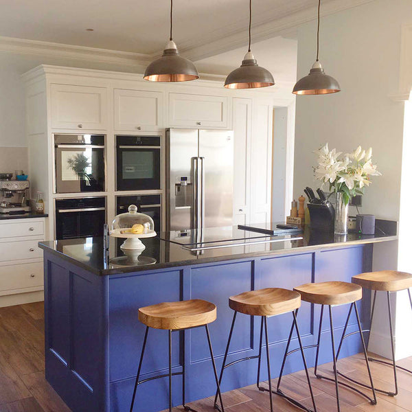 Kitchen island with bar stools and hanging ceiling lights