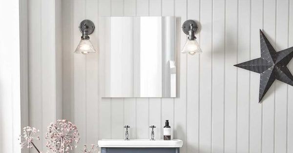 Neutral bathroom interior with pewter wall lights