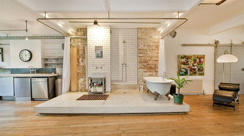 a warehouse style bathroom with vintage fittings and decorations