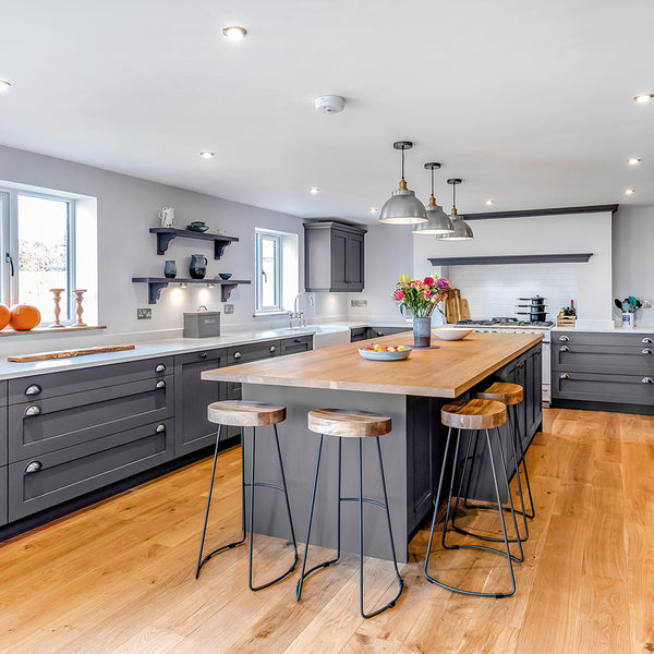 gray and white coloured kitchen, hanging light fixtures in line with interior lighting trends