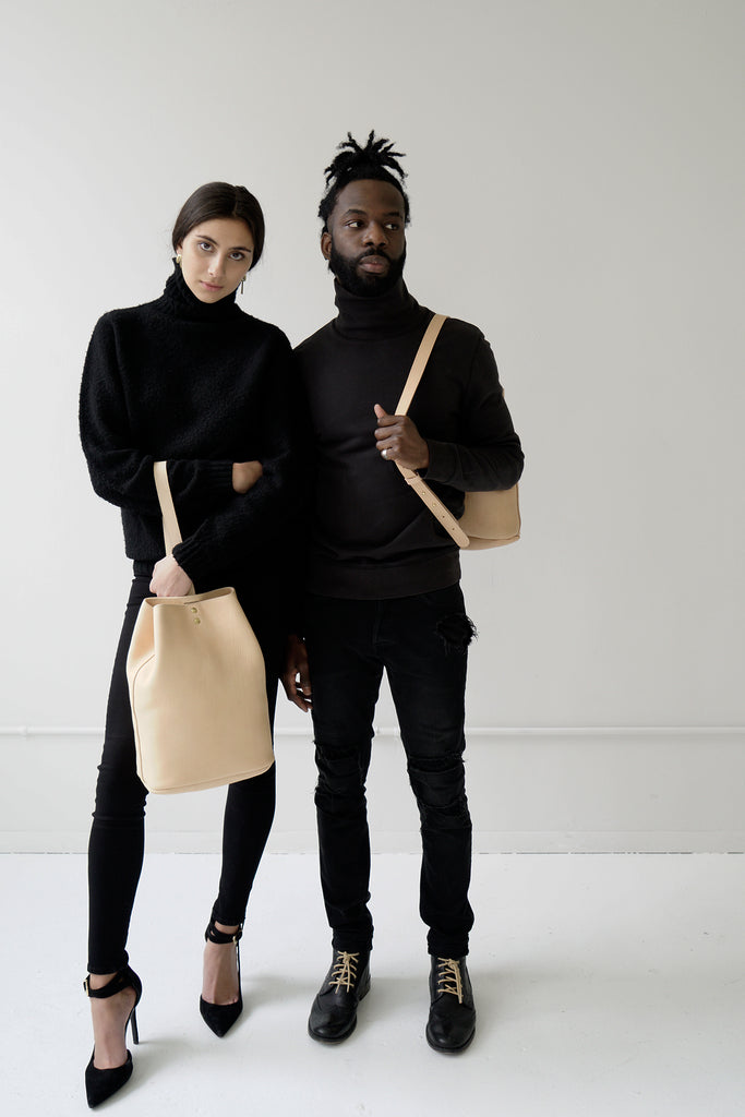 male model and female model with leather bucketbags