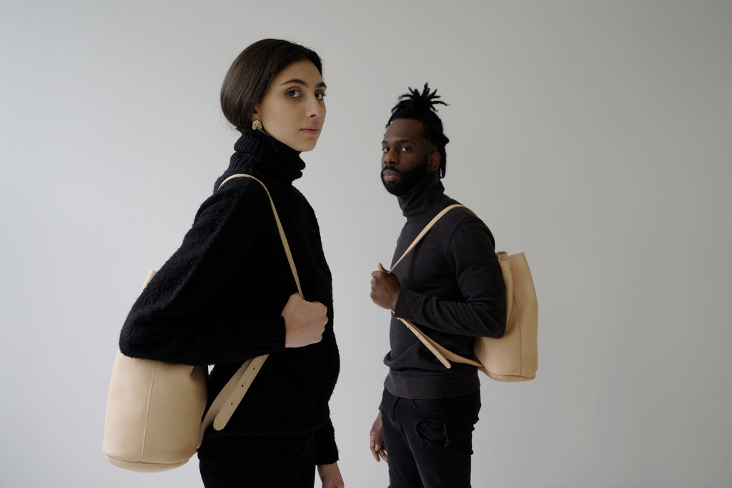 male model and female model with leather bucketbags