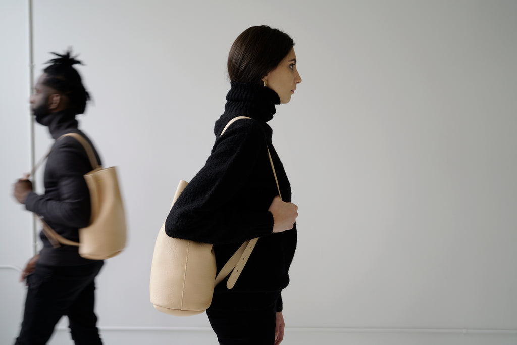 male model and female model with leather bucketbags