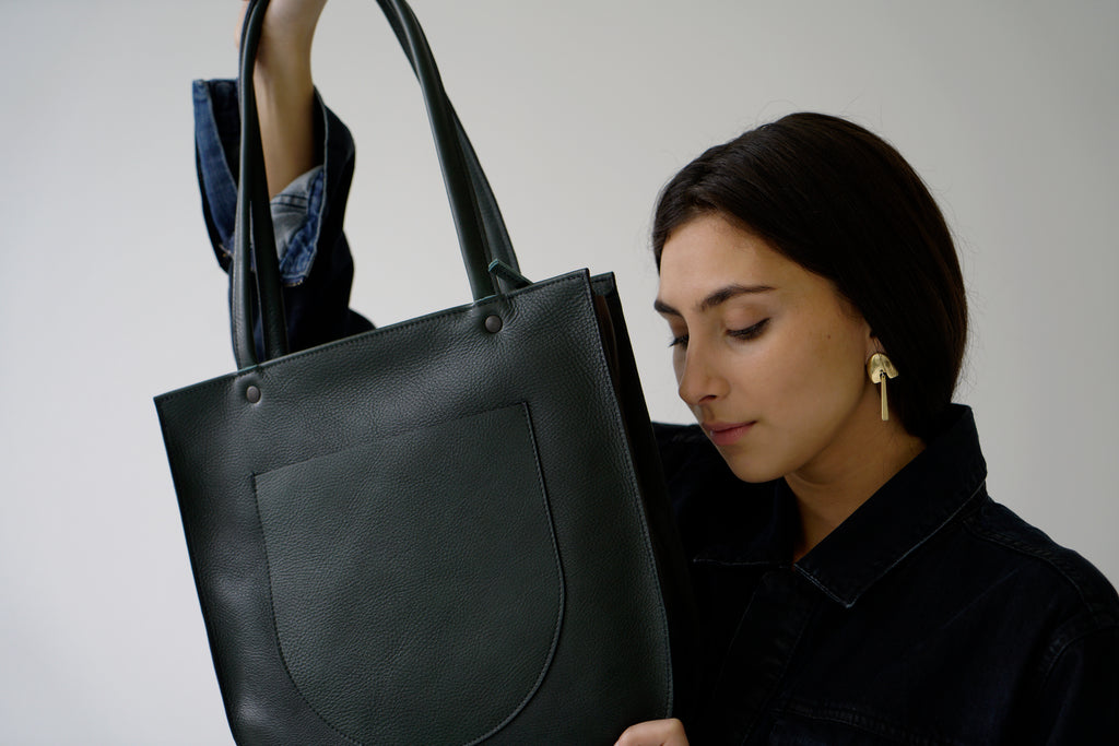 Female model with green leather bag